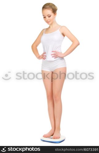 Young healthy girl on scales isolated