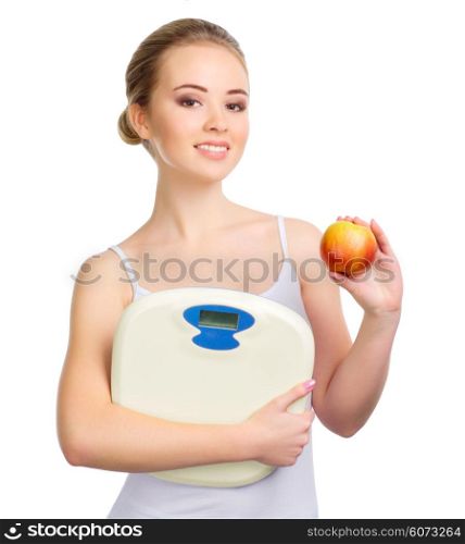 Young healthy girl with apple and scales isolated
