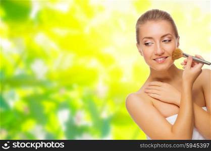 Young healthy girl with makeup brush isolated