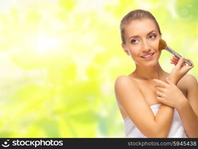 Young healthy girl with makeup brush isolated