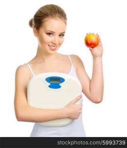 Young healthy girl with scales and apple isolated