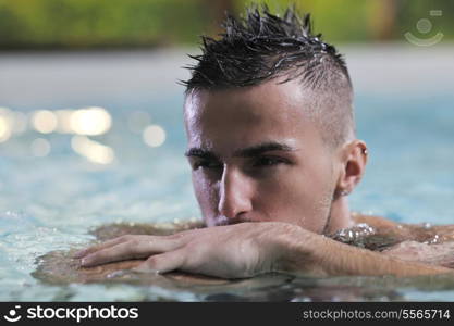 young healthy good looking macho man model athlete at hotel indoor pool