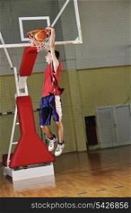 young healthy man play basketball game indoor in gym