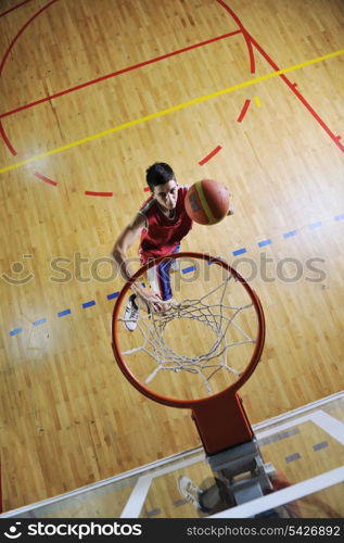 young healthy man play basketball game indoor in gym