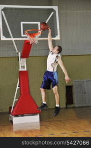 young healthy man play basketball game indoor in gym