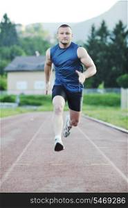 young healthy man run on athletic race sport track and representing concept of sort and speed