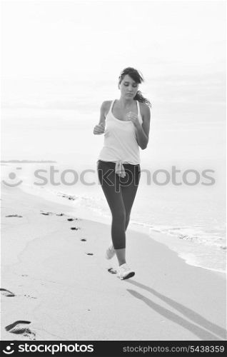 young healthy woman jogging and running at beach at early morning