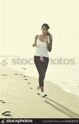 young healthy woman jogging and running at beach at early morning