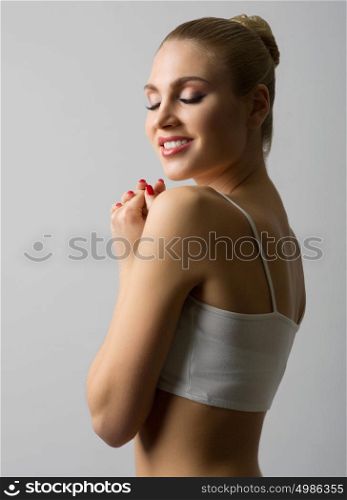 Young healthy woman on grey