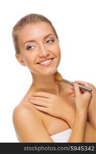 Young healthy woman with makeup brush isolated