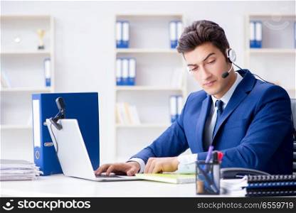 Young help desk operator working in office