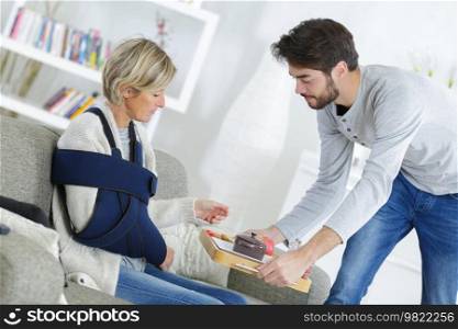 young helpful man spending time with injured lady