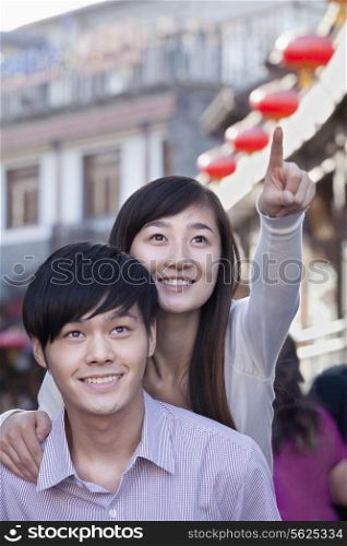 Young Heterosexual Couple Pointing Outdoors in Beijing