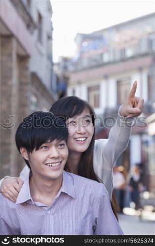 Young Heterosexual Couple Pointing Outdoors in Beijing