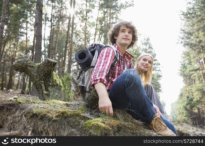 Young hiking couple relaxing in forest