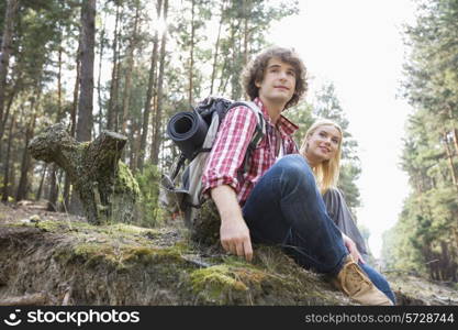 Young hiking couple relaxing in forest