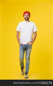 young hipster man wearing hat , suspenders, isolate on yellow background. young hipster man wearing hat , suspenders, isolate on yellow background.