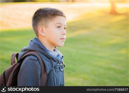 Young Hispanic Boy Walking Outdoors With Backpack. Young Hispanic Boy Walking Outdoors With Backpack.