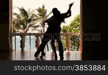 Young hispanic couple dancing latin american dance outdoors