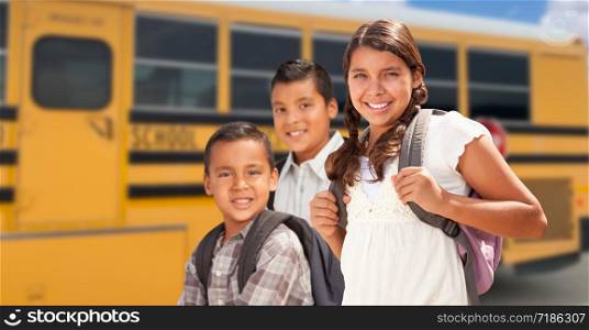 Young Hispanic Girl and Boys Walking Near School Bus.