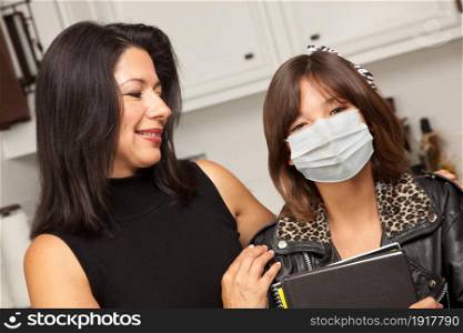 Young Hispanic Girl Student with Mother At Home Getting Ready For School Wearing Medical Face Mask.