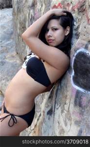Young Hispanic woman with a black bikini.