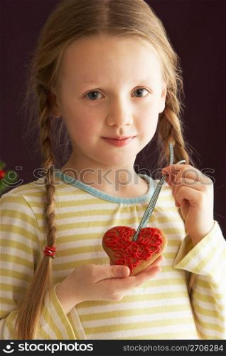Young Holding Heart Shaped Cookie In Studio