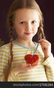 Young Holding Heart Shaped Cookie In Studio