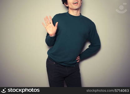 Young homosexual man is waving