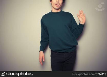 Young homosexual man is waving