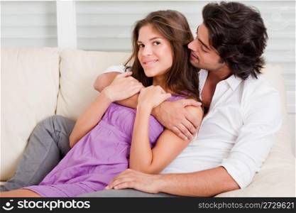 young honeymoon couple embracing at living room