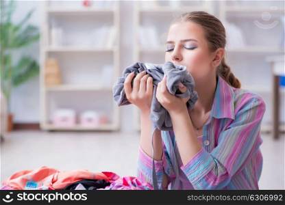 Young housewife doing laundry at home. The young housewife doing laundry at home