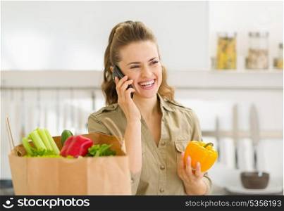 Young housewife sort purchases after shopping and talking mobile phone