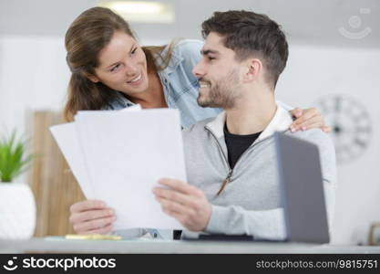 young husband and wife doing paperwork together