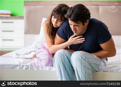 Young husband having problems with health in bedroom 