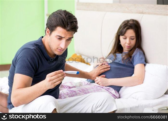 Young husband looking after his pregnant wife