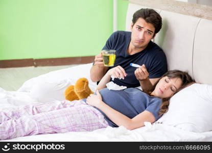 Young husband looking after his pregnant wife