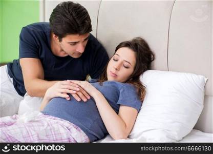 Young husband looking after his pregnant wife
