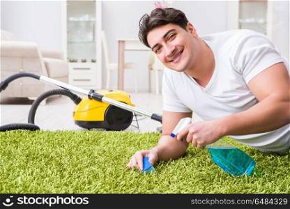 Young husband man cleaning floor at home