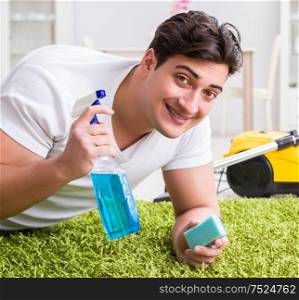 Young husband man cleaning floor at home. The young husband man cleaning floor at home