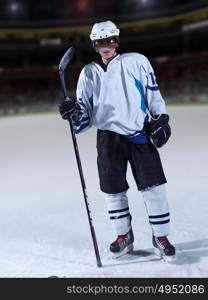 young ice hockey player portrait on training in black background