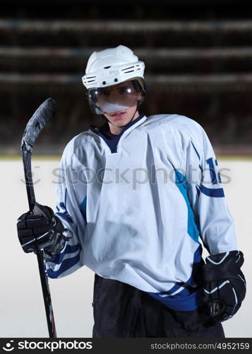 young ice hockey player portrait on training in black background