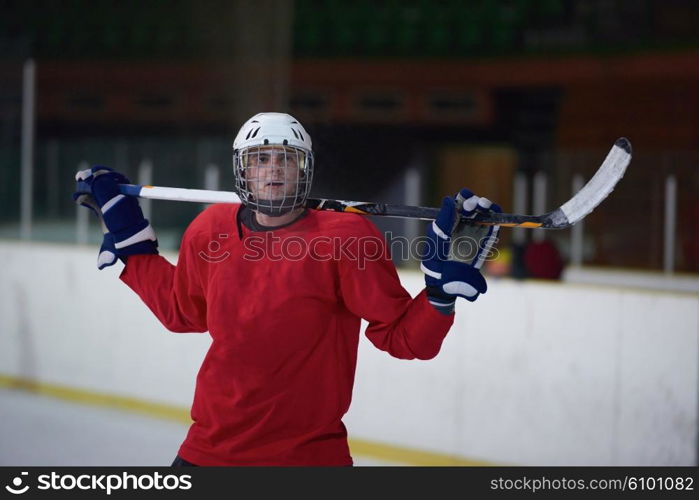 young ice hockey player portrait on training in black background