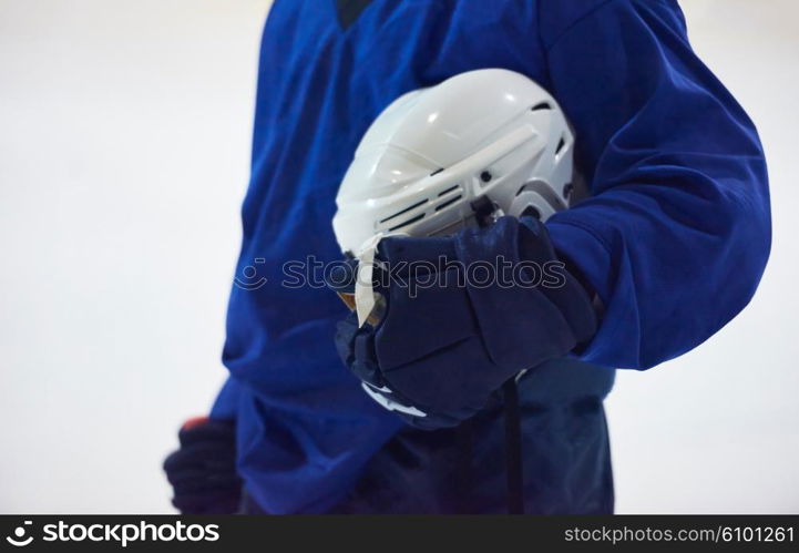 young ice hockey player portrait on training in black background