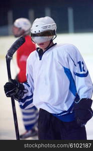 young ice hockey player portrait on training in black background