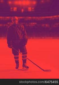 young ice hockey player portrait on training in black background. hockey player portrait