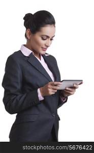 Young Indian businesswoman using digital tablet over white background