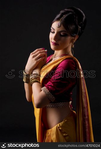 Young indian girl isolated on black