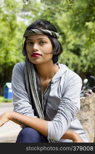 Young Indian girl with short hair wearing headgear and posing for camera, Pune. Young Indian girl with short hair wearing headgear and posing for camera, Pune.