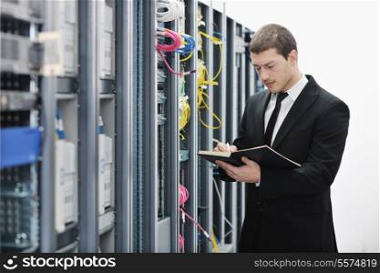 young it engeneer business man with notebook in network server room